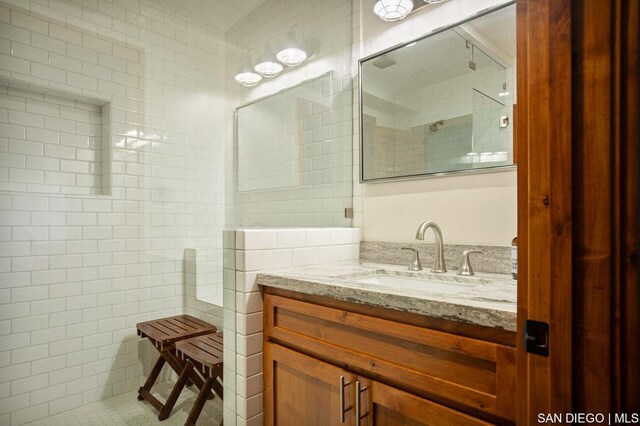 bathroom featuring vanity and tiled shower