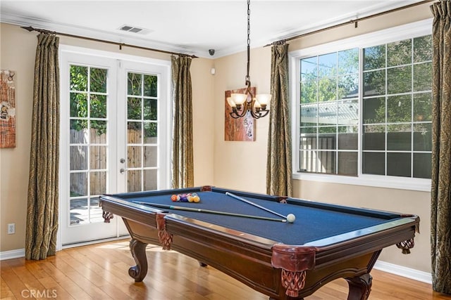 recreation room featuring hardwood / wood-style floors, crown molding, a notable chandelier, and pool table