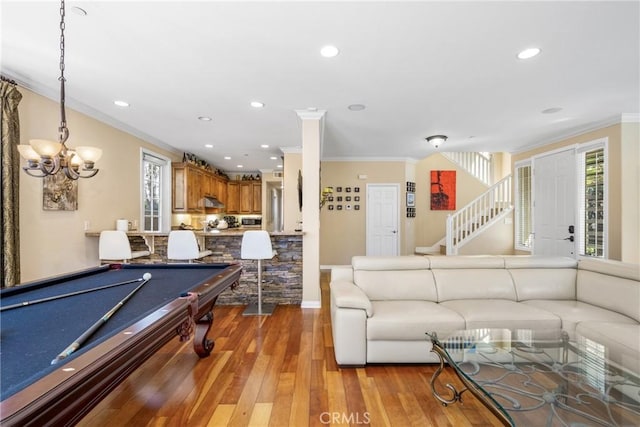 recreation room featuring hardwood / wood-style flooring, crown molding, billiards, and a chandelier