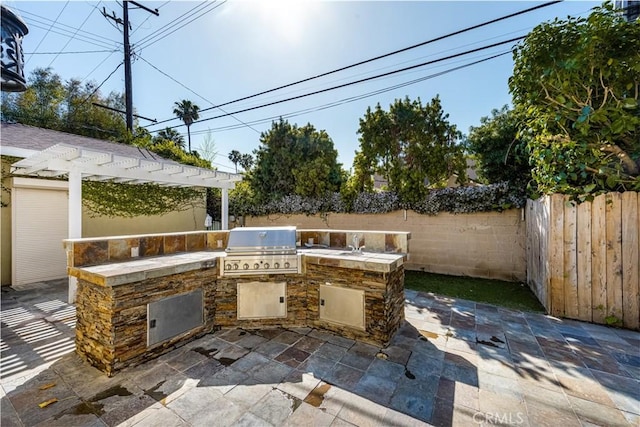 view of patio with a grill and a pergola