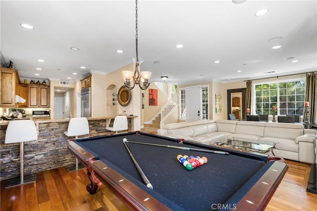 game room featuring crown molding, pool table, and light hardwood / wood-style flooring