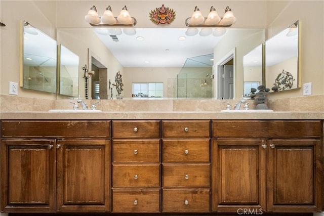 bathroom featuring vanity and a shower with door