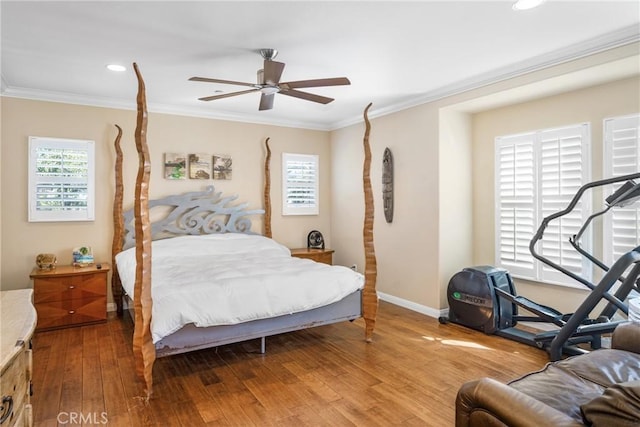 bedroom with ceiling fan, crown molding, and hardwood / wood-style flooring