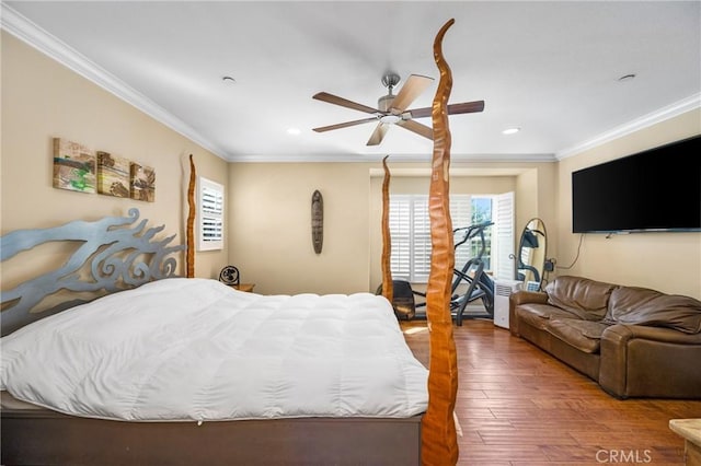 bedroom featuring ceiling fan, ornamental molding, and hardwood / wood-style flooring