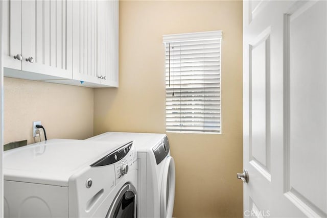 laundry area with cabinets and separate washer and dryer