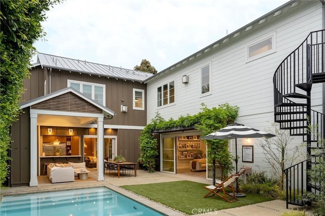 back of house with outdoor lounge area and a patio area