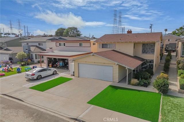 view of front of home featuring a garage and a front lawn