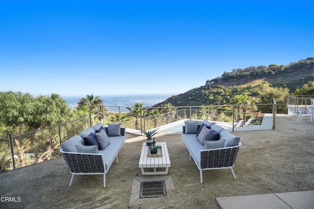 view of patio / terrace with a mountain view and an outdoor hangout area