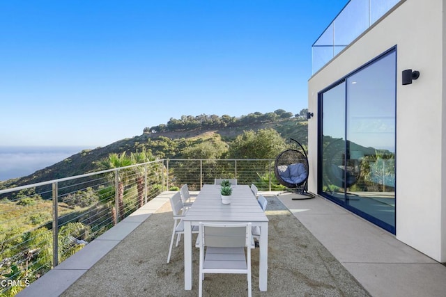 view of patio / terrace featuring a mountain view and a balcony