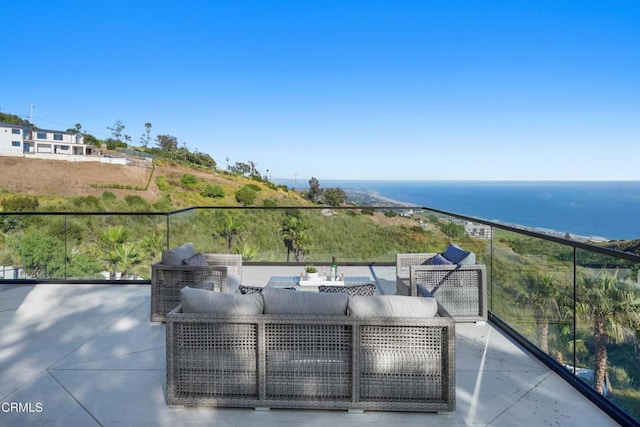 balcony with a water view, an outdoor hangout area, and a patio