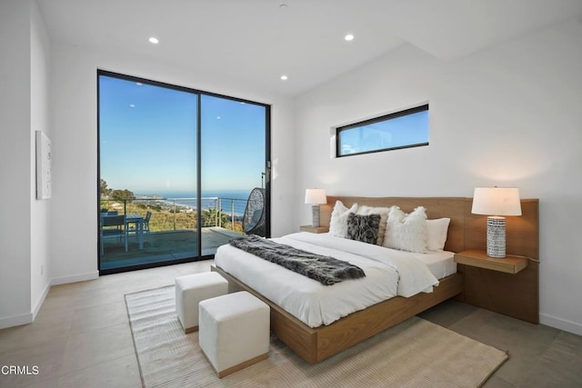 bedroom with access to outside and a water view