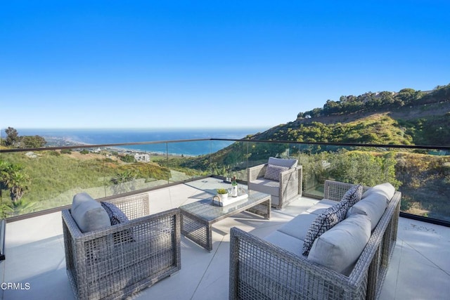 view of patio featuring outdoor lounge area and a water view