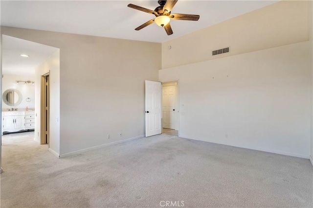 empty room with light carpet, ceiling fan, and lofted ceiling