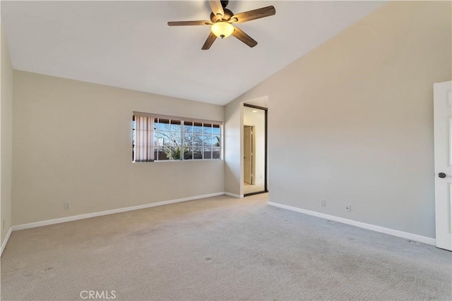 carpeted spare room featuring ceiling fan and lofted ceiling