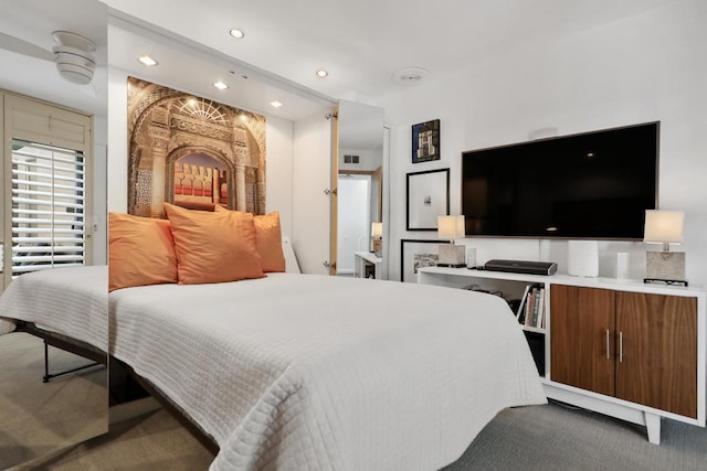 bedroom with ceiling fan and dark colored carpet