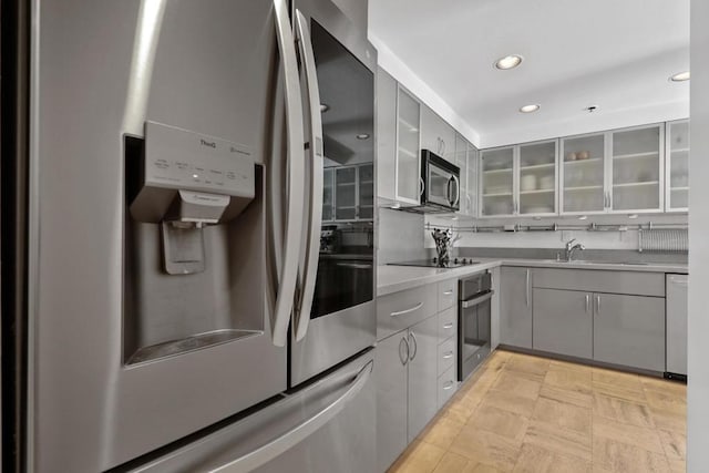 kitchen featuring gray cabinets, sink, and stainless steel appliances