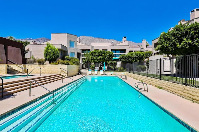 view of swimming pool featuring a mountain view and a patio