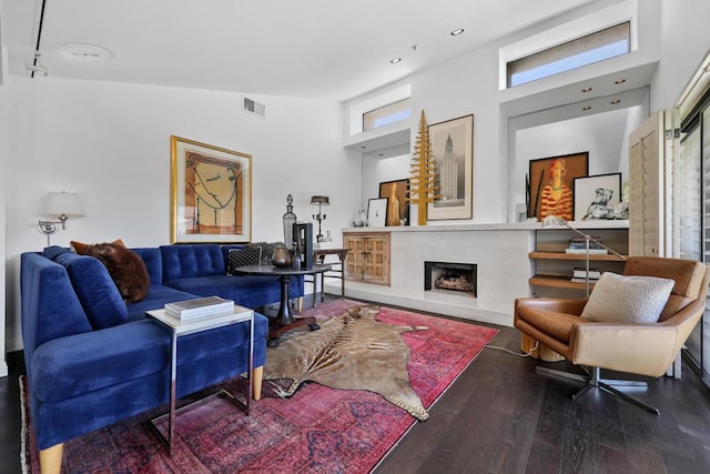 living room with high vaulted ceiling and wood-type flooring