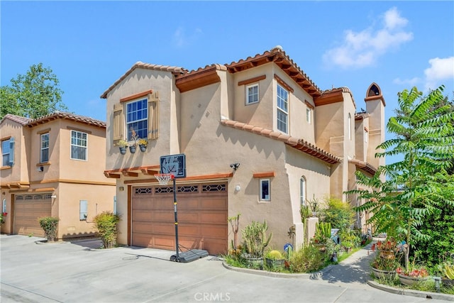 mediterranean / spanish-style home featuring a garage