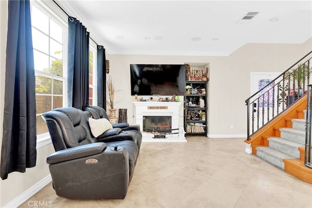 living room featuring ornamental molding and tile patterned flooring