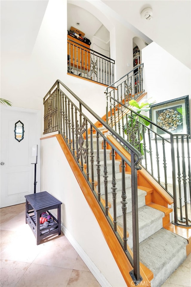 staircase with tile patterned floors