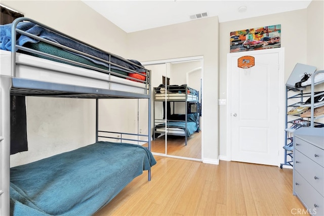 bedroom featuring a closet and light wood-type flooring