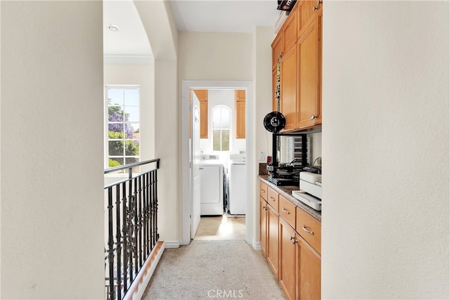 kitchen featuring separate washer and dryer and light colored carpet