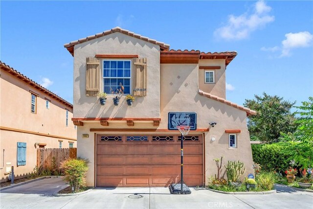 mediterranean / spanish home featuring a garage