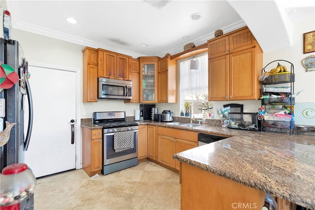 kitchen with light tile patterned flooring, dark stone countertops, crown molding, appliances with stainless steel finishes, and sink