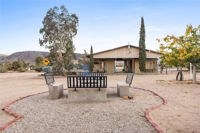 exterior space with a mountain view and a patio area