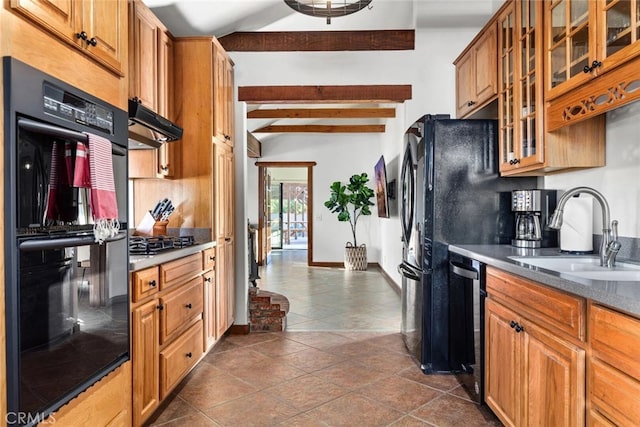 kitchen featuring stainless steel appliances, sink, and dark tile patterned flooring