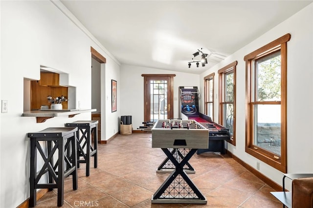 rec room with lofted ceiling and light tile patterned floors