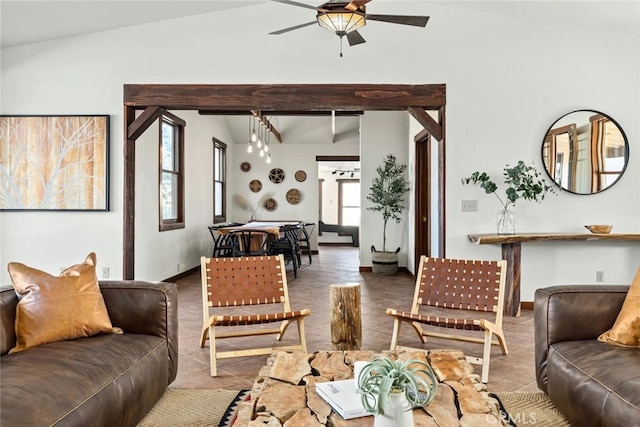 living room with ceiling fan, a healthy amount of sunlight, and vaulted ceiling