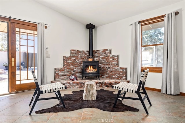 interior space with a wood stove and a wealth of natural light