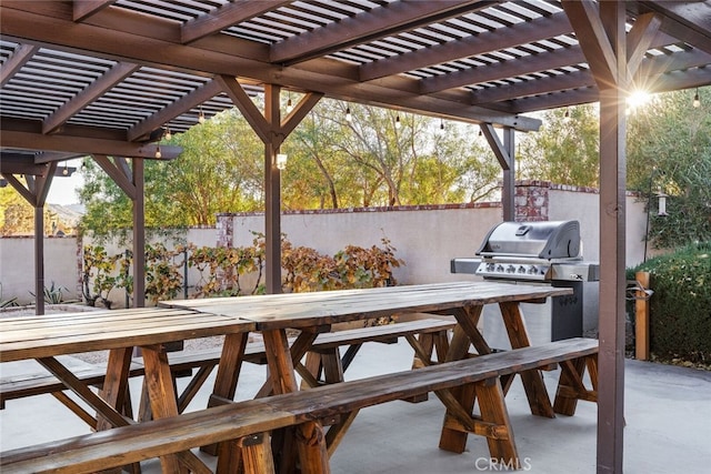 deck featuring an outdoor kitchen, area for grilling, a patio area, and a pergola