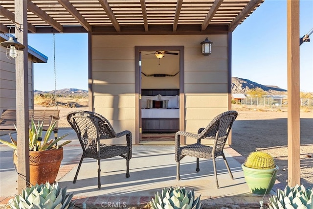 view of patio / terrace featuring a pergola and a mountain view