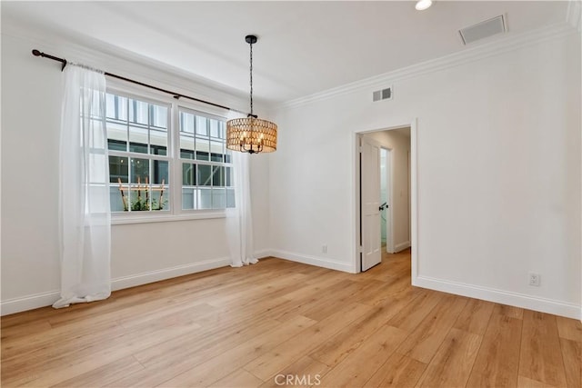 unfurnished dining area featuring a chandelier, light wood-type flooring, and ornamental molding