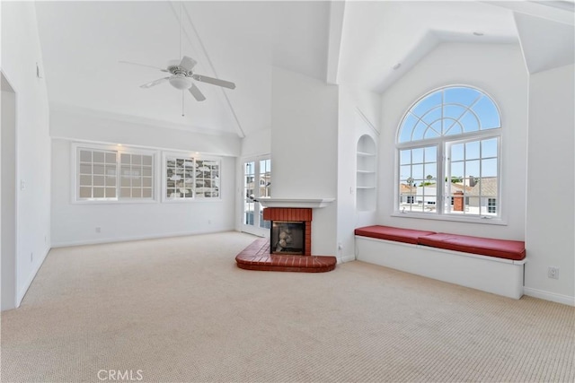 carpeted living room featuring plenty of natural light, lofted ceiling, and a fireplace