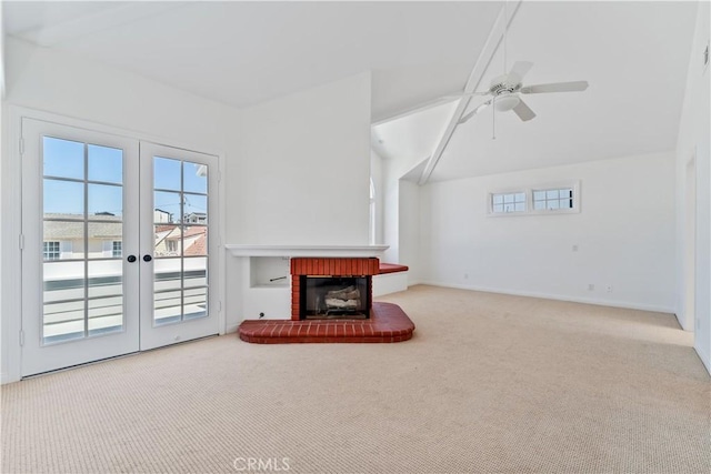 living room featuring ceiling fan, a fireplace, carpet floors, and french doors