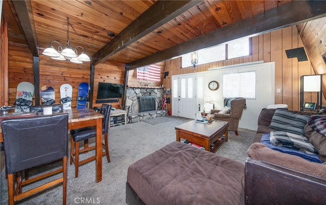 carpeted living room featuring wood ceiling, a fireplace, wooden walls, and beamed ceiling