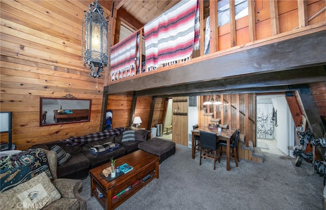 carpeted living room with wooden walls and wood ceiling