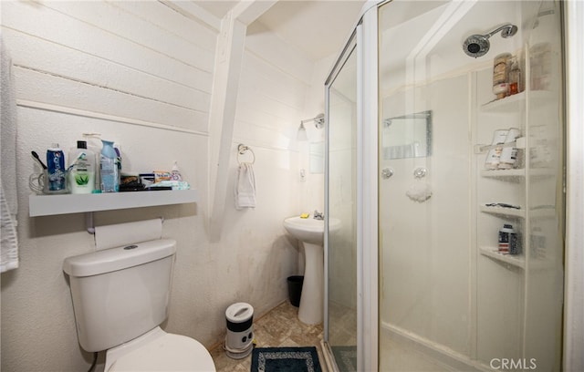 bathroom featuring walk in shower and toilet