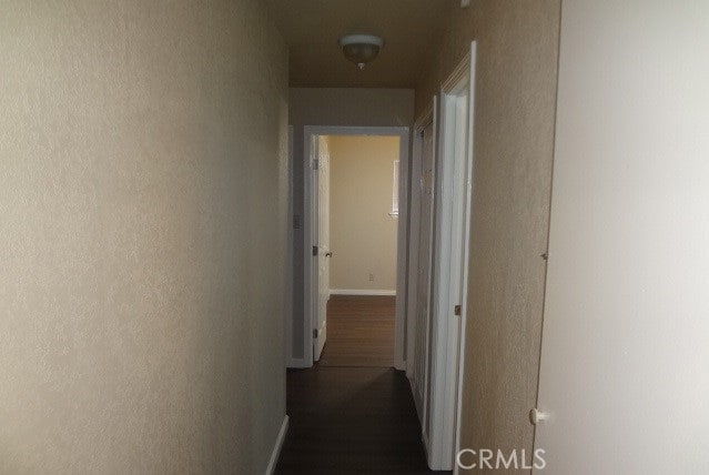 corridor featuring dark hardwood / wood-style flooring