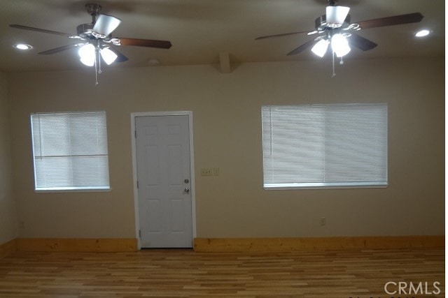 unfurnished room with ceiling fan and hardwood / wood-style flooring