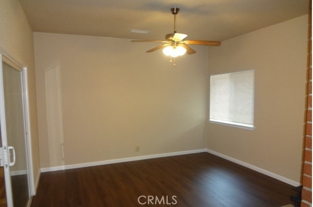 unfurnished room featuring ceiling fan and dark wood-type flooring