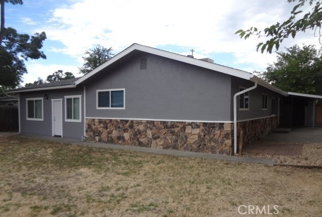 view of side of property with a lawn