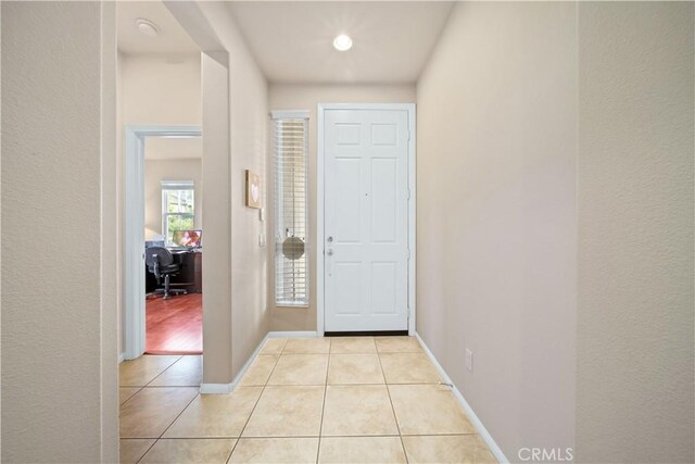 foyer entrance with light tile patterned floors