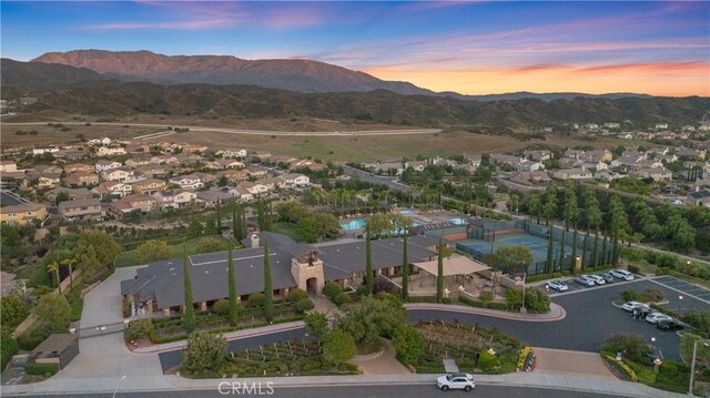 aerial view at dusk featuring a mountain view