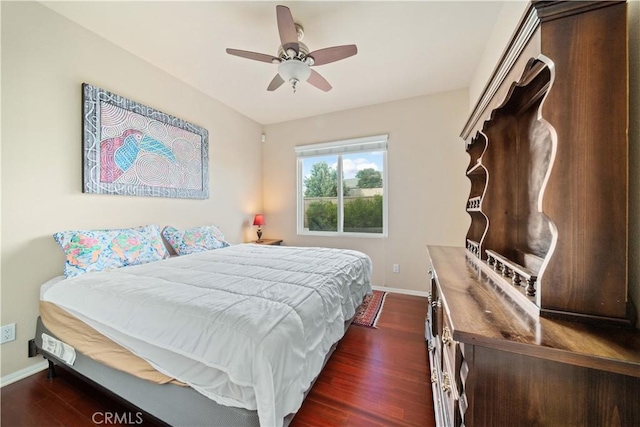 bedroom with ceiling fan and dark wood-type flooring