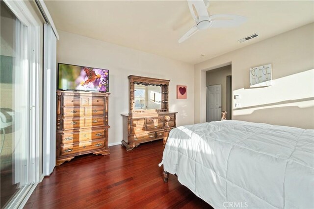 bedroom with ceiling fan and dark hardwood / wood-style floors